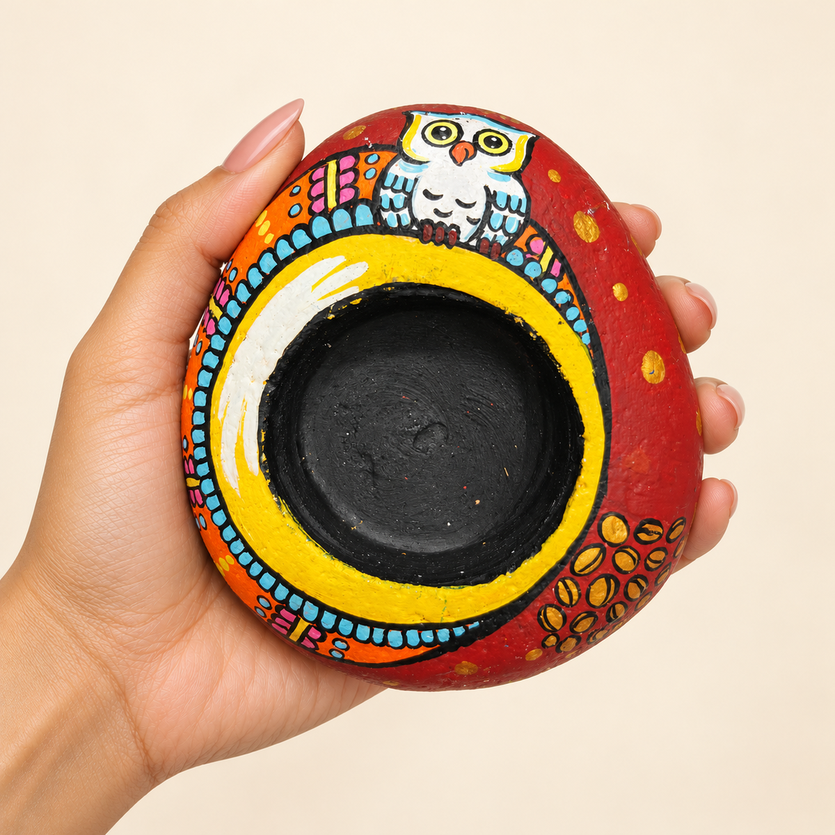Owl Crown: Sunlit Arch hand-painted natural pebble tealight holder, shown in hand for scale