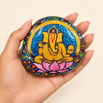 Ganesh: Lotus Radiance hand-painted natural pebble art, shown in hand for scale