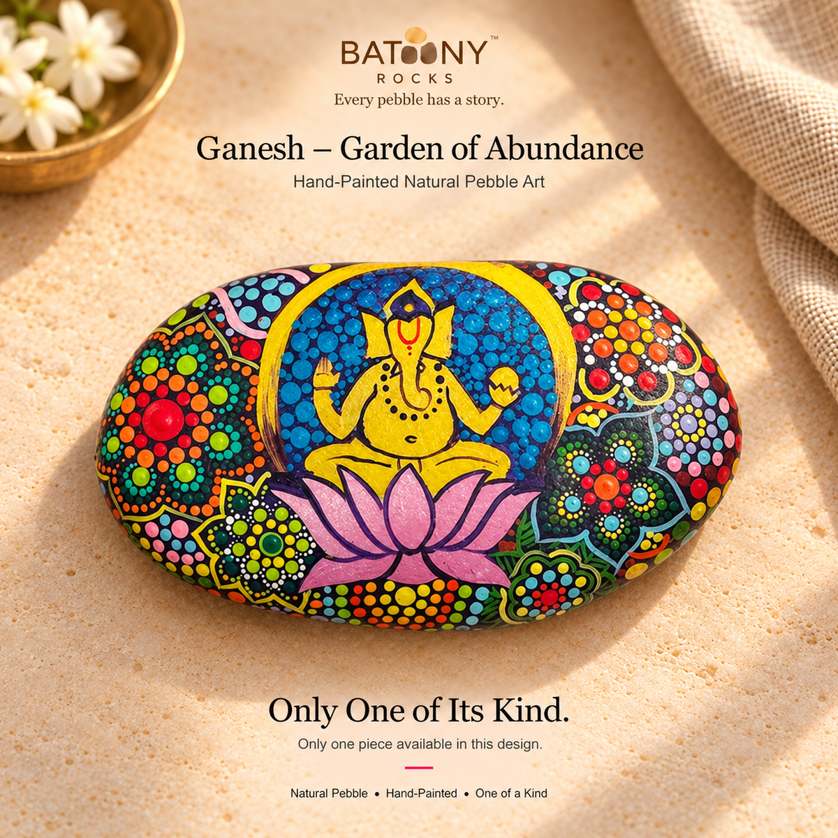 Ganesh: Garden of Abundance hand-painted natural pebble art, on a warm stone surface