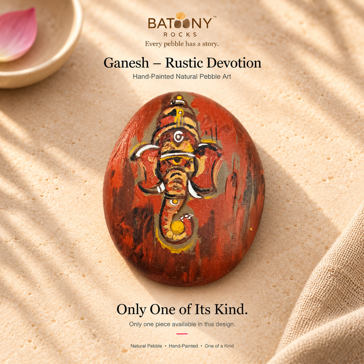 Ganesh: Rustic Devotion hand-painted natural pebble art, on a warm stone surface