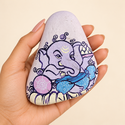 Ganesh: Lavender Calm hand-painted natural pebble art, shown in hand for scale