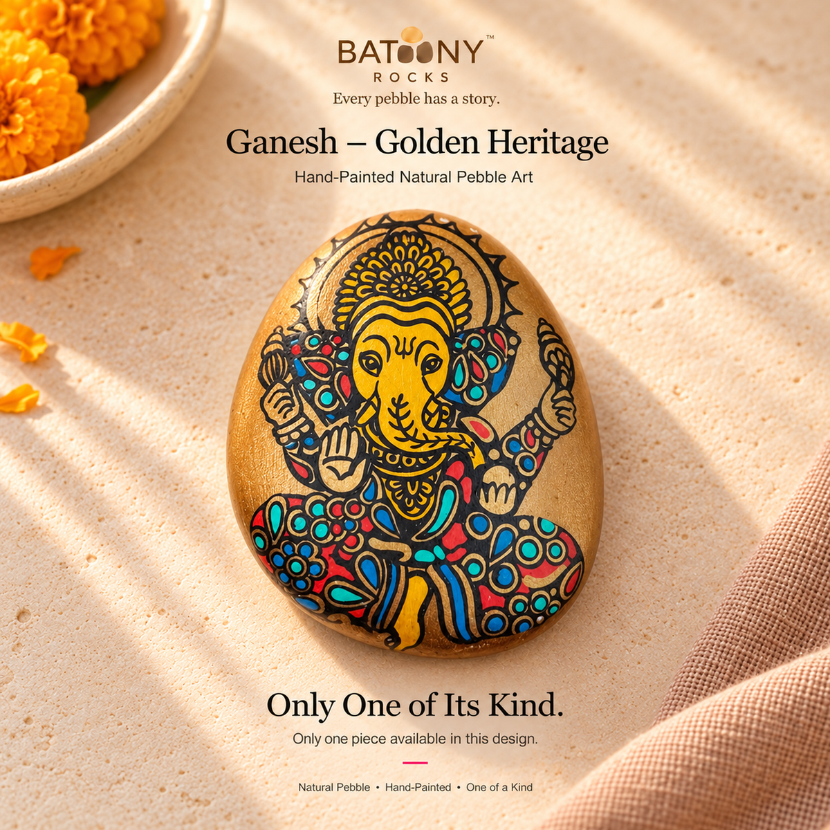 Ganesh: Golden Heritage hand-painted natural pebble art, on a warm stone surface