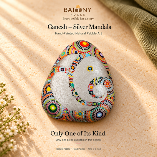 Ganesh: Silver Mandala hand-painted natural pebble art, on a warm stone surface