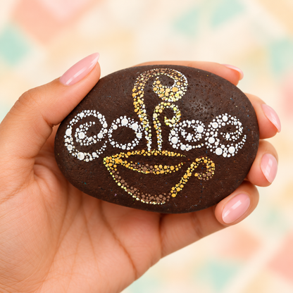 Coffee and Colour: Everyday Muse: selected hand-painted pebble held in hand