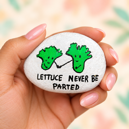 Lettuce Never Be Parted: selected hand-painted pebble held in hand