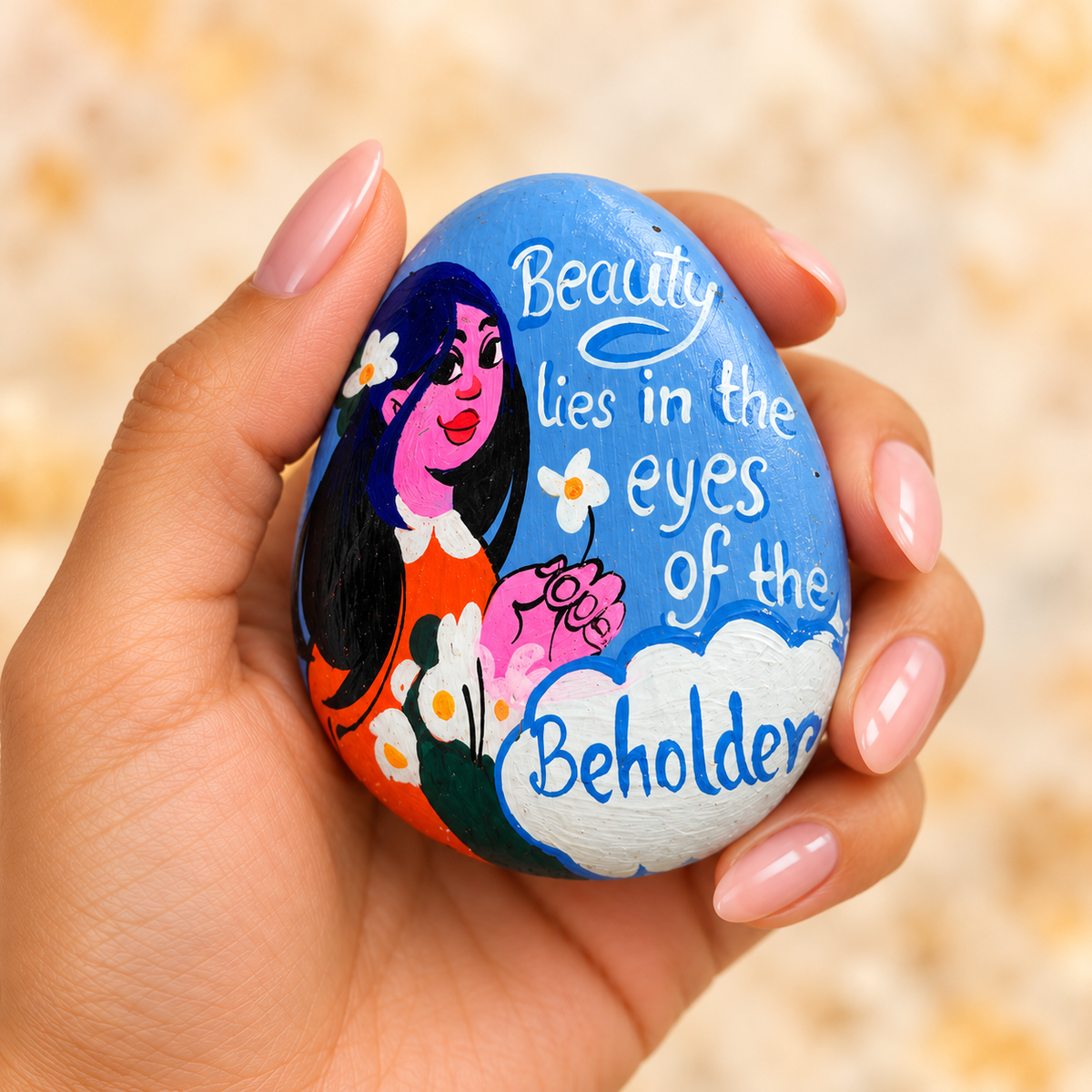 Beauty: Through Your Eyes: selected hand-painted pebble held in hand
