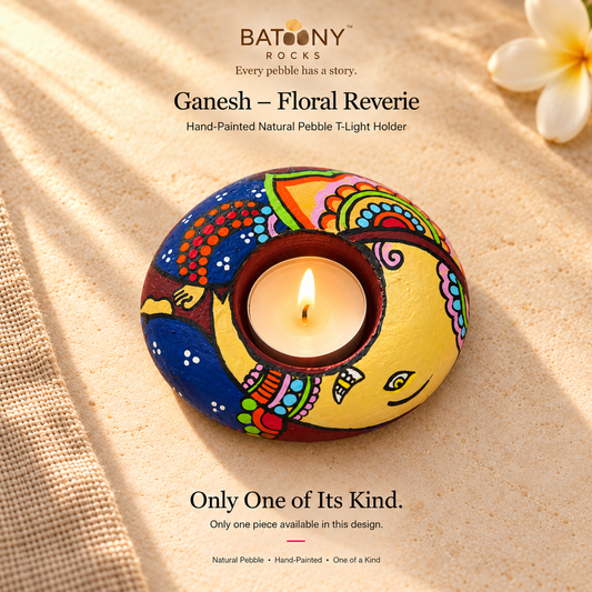 Ganesh: Floral Reverie hand-painted natural pebble tealight holder, on a warm stone surface
