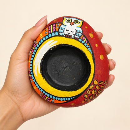 Owl Crown: Sunlit Arch hand-painted natural pebble tealight holder, shown in hand for scale