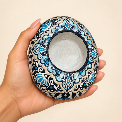 Indigo Paisley: Pearl Garden hand-painted natural pebble tealight holder, shown in hand for scale