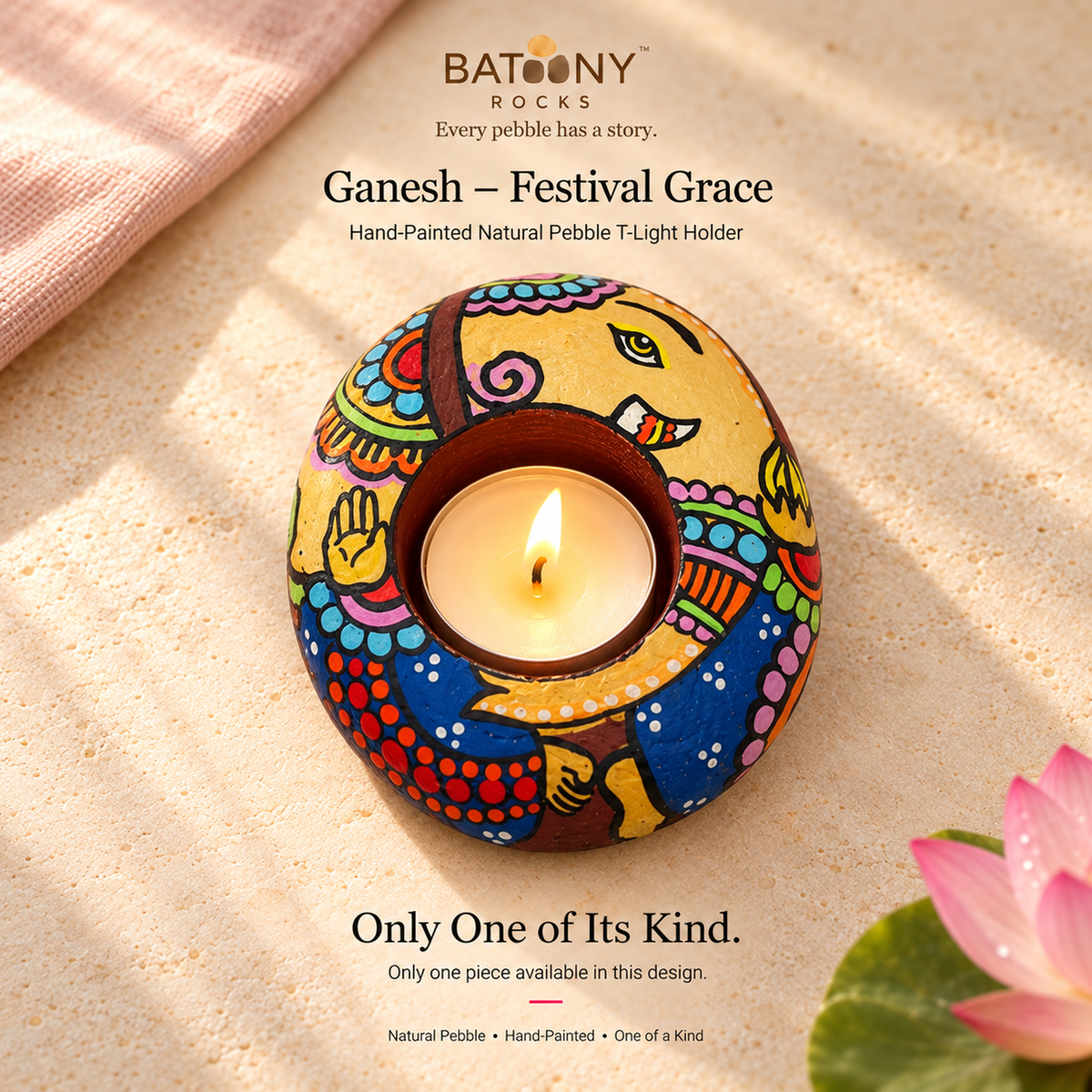 Ganesh: Festival Grace hand-painted natural pebble tealight holder, on a warm stone surface
