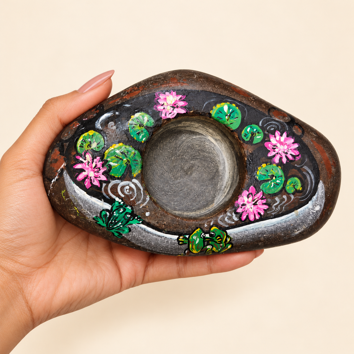 Lotus Pond: River Garden hand-painted natural pebble tealight holder, shown in hand for scale