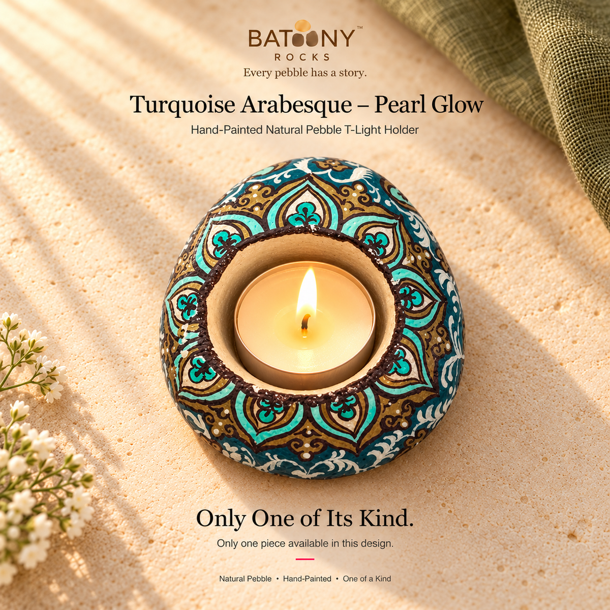 Turquoise Arabesque: Pearl Glow hand-painted natural pebble tealight holder, on a warm stone surface