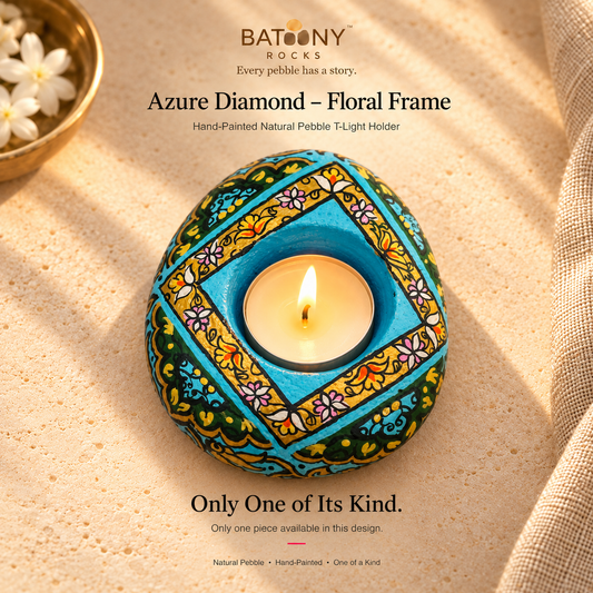 Azure Diamond: Floral Frame hand-painted natural pebble tealight holder, on a warm stone surface