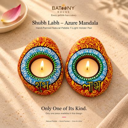 Shubh Labh: Azure Mandala hand-painted natural pebble tealight holder, on a warm stone surface