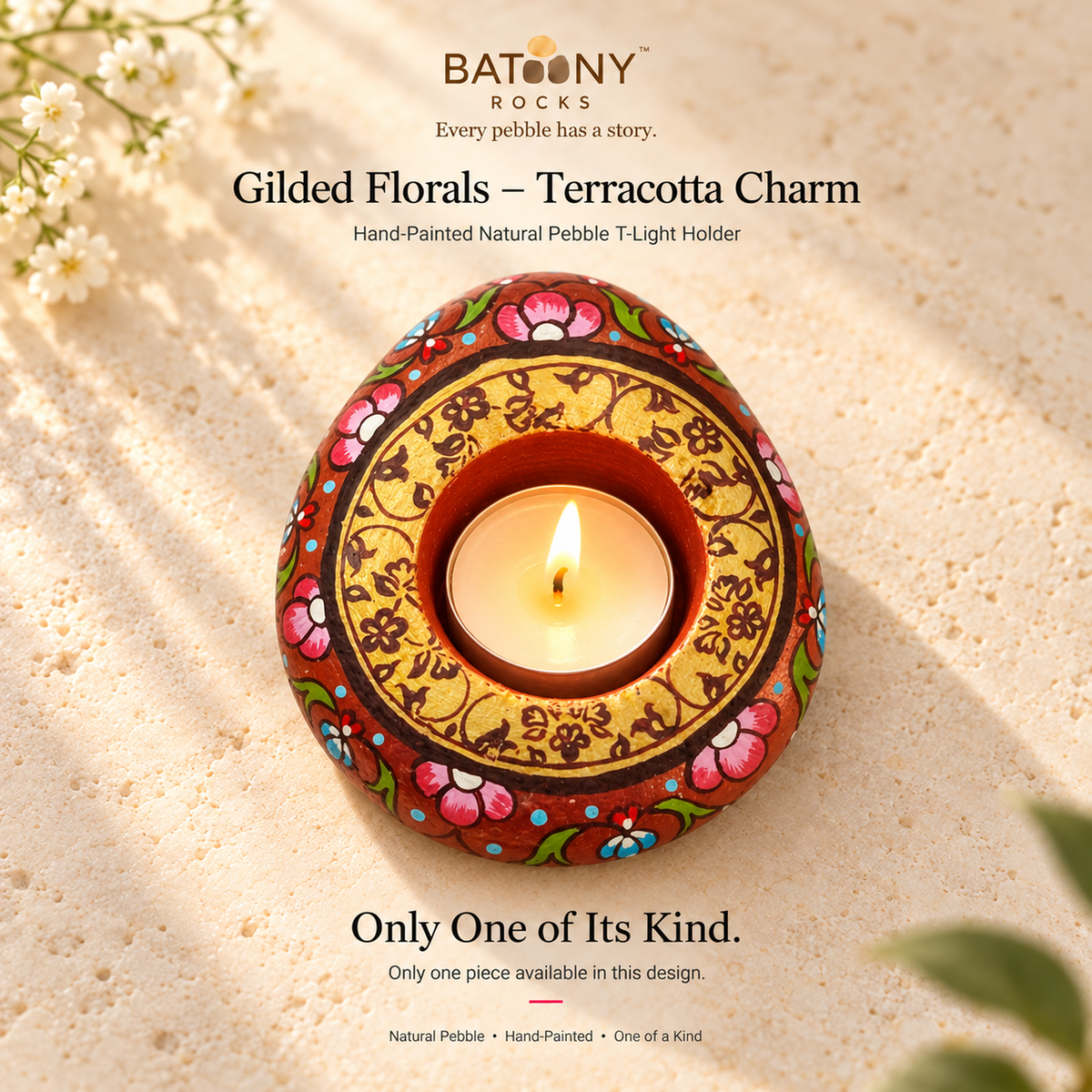 Gilded Florals: Terracotta Charm hand-painted natural pebble tealight holder, on a warm stone surface