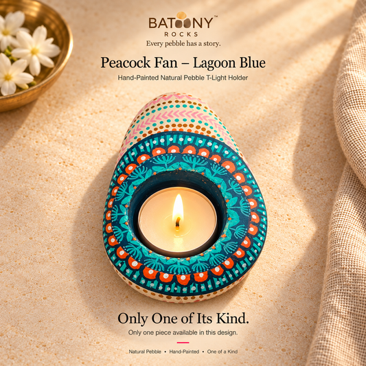 Peacock Fan: Lagoon Blue hand-painted natural pebble tealight holder, on a warm stone surface