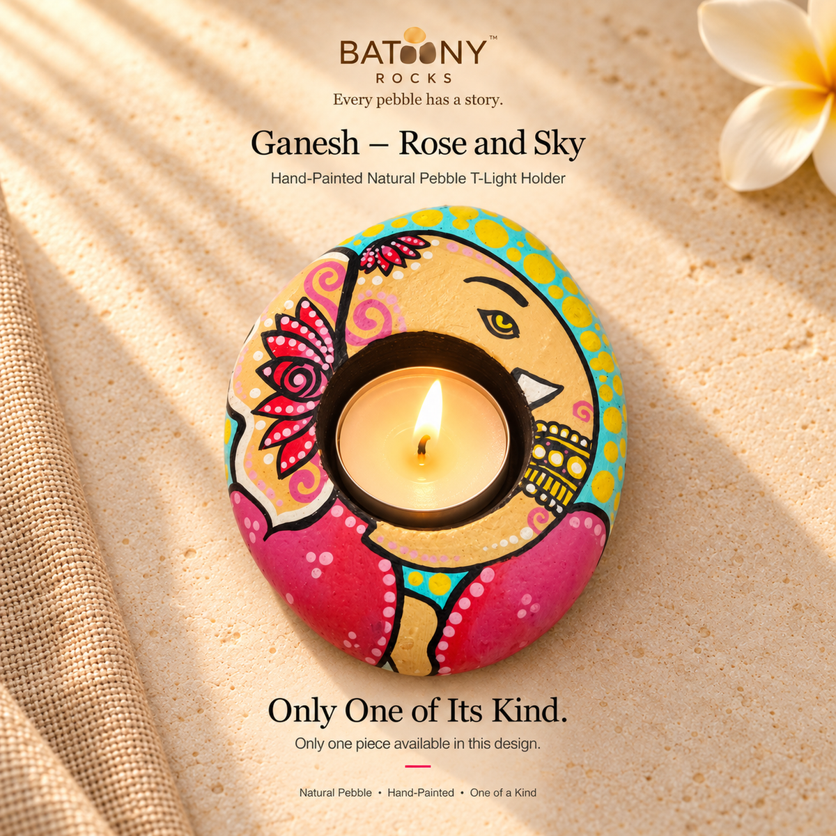 Ganesh: Rose and Sky hand-painted natural pebble tealight holder, on a warm stone surface