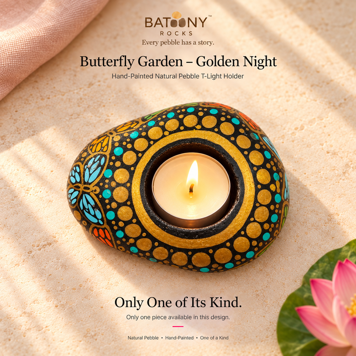 Butterfly Garden: Golden Night hand-painted natural pebble tealight holder, on a warm stone surface