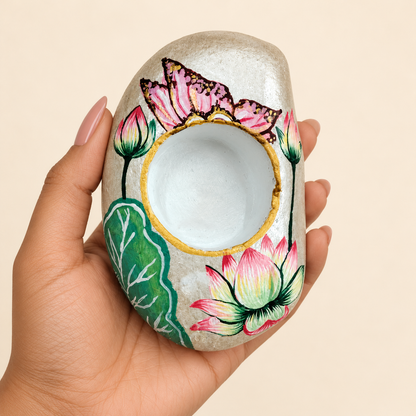 Lotus: Pearl Blossom hand-painted natural pebble tealight holder, shown in hand for scale