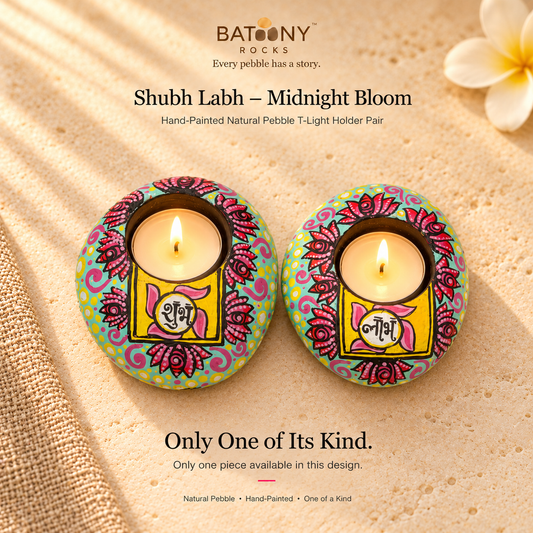 Shubh Labh: Midnight Bloom hand-painted natural pebble tealight holder, on a warm stone surface