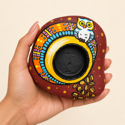 Wise Owl: Rainbow Arch hand-painted natural pebble tealight holder, shown in hand for scale