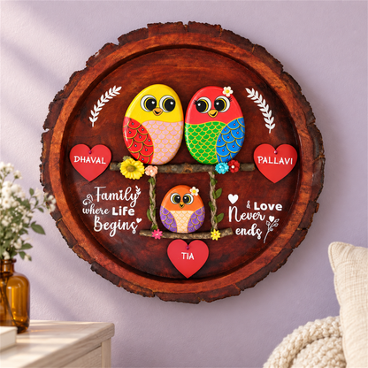 Blissful Bond Trio Pebble Art: two birds above a smaller bird on a swing with red heart name tags, in a home setting