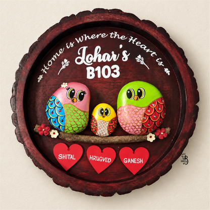 Joy Junction Pebble Art: three colourful birds with red heart name tags on dark round wood, on a beige background