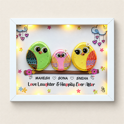 Spark of Grace Trio: green, pink and yellow little birds on a flower-trimmed branch, white frame, on a beige background