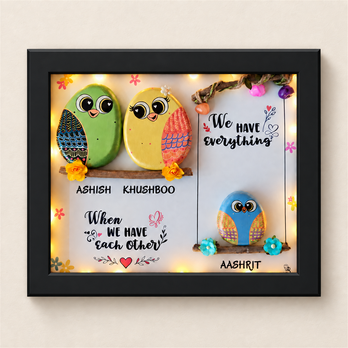Sweet & Nutty Bond Pebble Art: three little birds on two branches with a family message, black frame, on a beige background