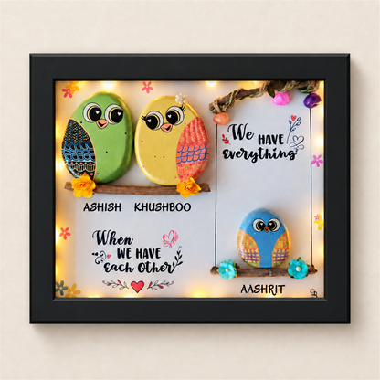 Sweet & Nutty Bond Pebble Art: three little birds on two branches with a family message, black frame, on a beige background