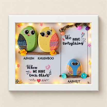 Sweet & Nutty Bond Pebble Art: three little birds on two branches with a family message, white frame, on a beige background