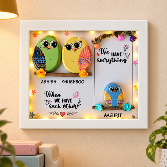 Sweet & Nutty Bond Pebble Art: three little birds on two branches with a family message, white frame, in a home setting
